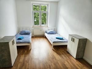 a room with two beds and a window at AC01-AC06 Apartment in Herzogenrath in Herzogenrath