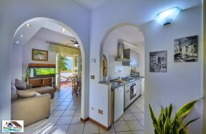 a kitchen with an archway and a living room at Mary house lake view in Varenna +23 photos