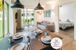 a living room with a table and a couch at Marissa Resort in Lembruch +84 photos