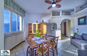 a living room with a table and a couch at Mary house lake view in Varenna