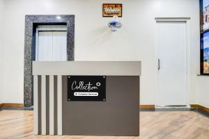 a room with a wall with a sign on it at Super Collection O Pashan-Sus Road Baner Formerly Grey Stone in Pune