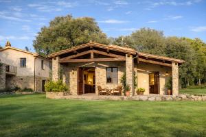 a house with a large yard with green grass at Podere Montale Il Borgo in Seggiano