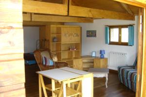 a living room with a table and a couch at Paysannerie des Versanes - Chambre et gîte à la ferme in Tour-de-Faure