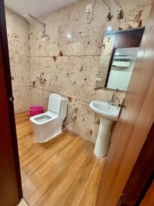 a bathroom with a sink and a toilet in it at Jeevak hotel in Mohali