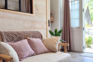 a living room with a couch and a window at Gîte de charme Beaujoyeulx in Molineuf +26 photos