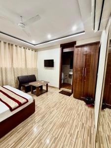 a hotel room with a bed and a table at Jeevak hotel in Mohali