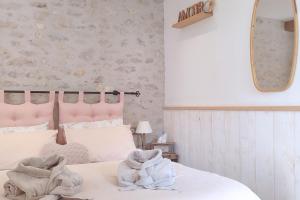 a bedroom with a white bed and a mirror at Gîte de charme Beaujoyeulx in Molineuf