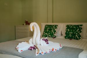 two swans made out of towels on a bed at Lime Splash Private pool in Choeng Mon Beach