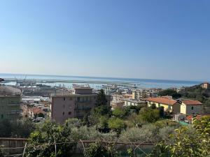 a view of a city with the ocean in the background at Villa Mare & Monti in Genoa