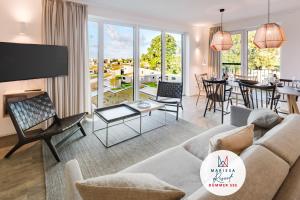 a living room with a couch and a table at Marissa Resort in Lembruch