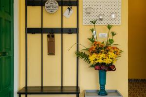 a vase with flowers on a table next to a wall at Lime Splash Private pool in Choeng Mon Beach +41 photos
