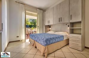 a bedroom with a bed and a door to a patio at Mary house lake view in Varenna