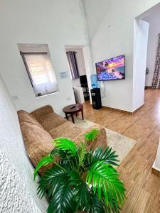 a living room with a couch and a table at CLASSIC BNBs MILIMANI in Kisumu
