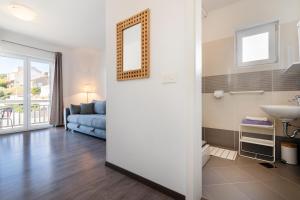a living room with a blue couch and a sink at Guest House Kovacevic in Hvar +70 photos