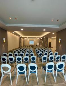 a room with rows of chairs and a podium at Hotel Olanesti & Spa Medical in Băile Olăneşti +68 photos