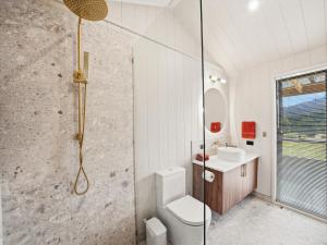 a bathroom with a shower and a toilet and a sink at Maydena Alpine Retreat in Maydena +32 photos