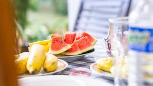 two plates of fruit sitting on a table at Villa Swallow Nest in Sigiriya