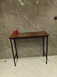 a wooden table with a red cup on top of it at DREAM Room , AJMAN in Ajman 