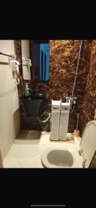 a bathroom with a toilet and a sink and a mirror at DREAM Room , AJMAN in Ajman 