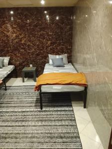 a bed in a room with a wall at DREAM Room , AJMAN in Ajman 