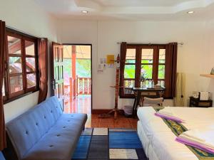 a living room with a couch and a table at Samma Karuna Beach & Wellness Resort - Intoxicants free in Srithanu