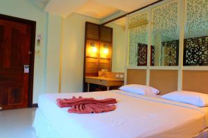 a bedroom with a large white bed with red towels on it at PSHill in Ao Nang Beach