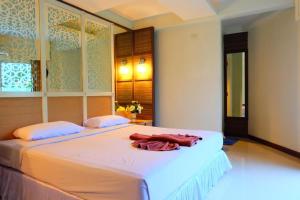 a bedroom with a bed with a robe on it at PSHill in Ao Nang Beach