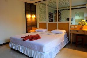 a bedroom with a bed with a red robe on it at PSHill in Ao Nang Beach
