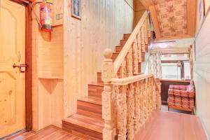a wooden staircase in a home with wooden floors at Collection O Foreshore Road Srinagar in Srinagar