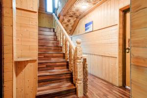 a staircase in a house with wooden walls at Collection O Foreshore Road Srinagar in Srinagar