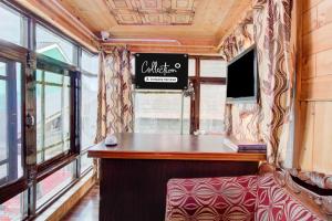 a bar on a train with a sign on the wall at Collection O Foreshore Road Srinagar in Srinagar