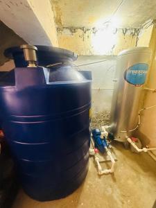 two blue barrels sitting on the floor in a room at The Penthouse With Outdoor Jacuzzi Private Rooftop Solar Powered Energy in Puerto Princesa City +38 photos