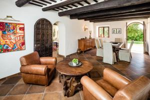 a living room with leather furniture and a table at Villa Uliveto in Staffolo