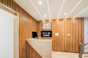 an office lobby with wooden walls and a reception desk at Hotel O Mahakal Temple Formerly Shivangam in Ujjain