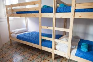 a bunk bed with blue bunk beds in a room at Bed in Girona in Girona
