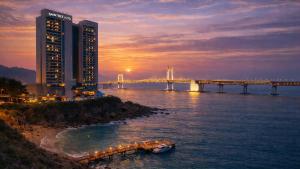 a bridge over the water with a building and a bridge at SainTree Hotel in Incheon +10 photos