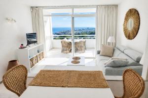 a living room with a couch and a table at Secret View Riviera Miraflores in La Cala de Mijas