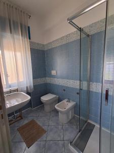 a bathroom with a toilet and a sink and a shower at B&B Vista Mare in Belvedere Marittimo