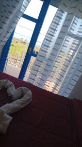 a bedroom with a bed and a large window at B&B Vista Mare in Belvedere Marittimo