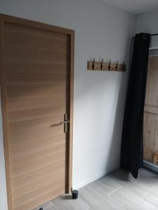 a wooden door in a room next to a wall at L'Ancienne Etable in Gentelles