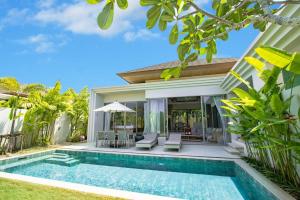 a swimming pool in front of a villa at Villa 24 3BR Trichada Breeze in Phuket