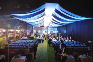 a banquet hall with tables and chairs and people at Grand Heritage Narmada Jacksons in Jabalpur +100 photos