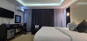a hotel room with a large bed and a desk at Brus View Suites in Ilado +2 photos