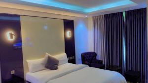 a hotel room with a bed and a chair at Brus View Suites in Ilado