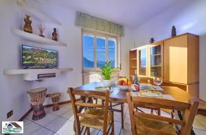 a kitchen with a dining room table and chairs at Mary house lake view in Varenna