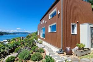 a brick house with a view of the water at Orchard 123 Private Pension in Yeosu