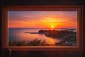 a painting of a sunset over a body of water at Orchard 123 Private Pension in Yeosu