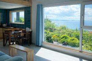 a dining room with a table and a large window at Orchard 123 Private Pension in Yeosu +7 photos
