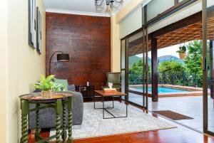 a living room with a couch and a table at Hoyozela in Hartbeespoort