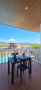 a table and chair on a balcony with a view at Calamianes Homestay in Coron
